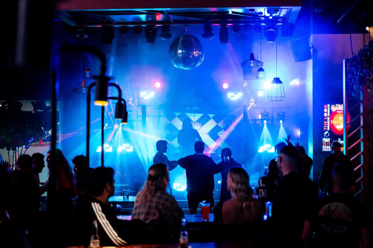 Dance floor under blue lights and a disco ball at The Landing